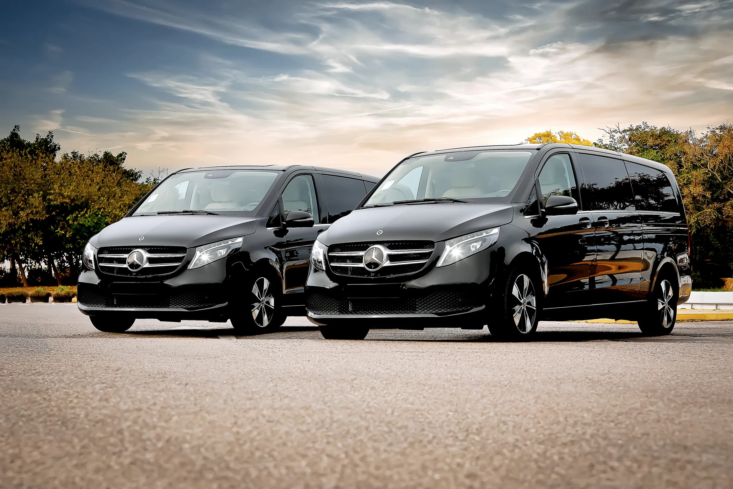 A pair of black Mercedes V-Class vehicles in Ibiza