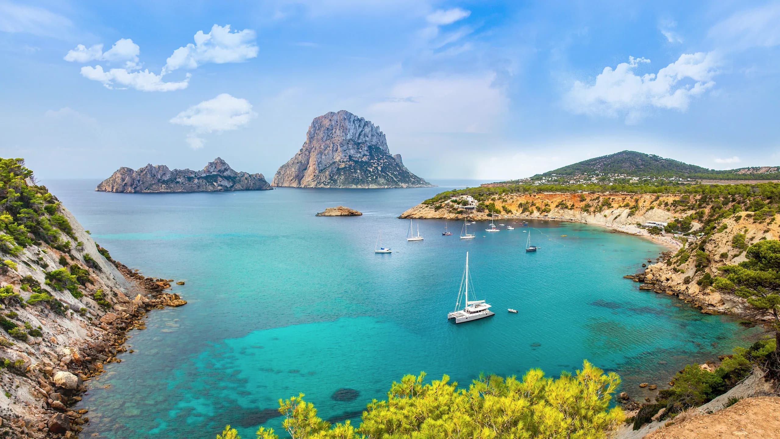 Es Vedrà rising beyond the turquoise water of Cala d'Hort, Ibiza